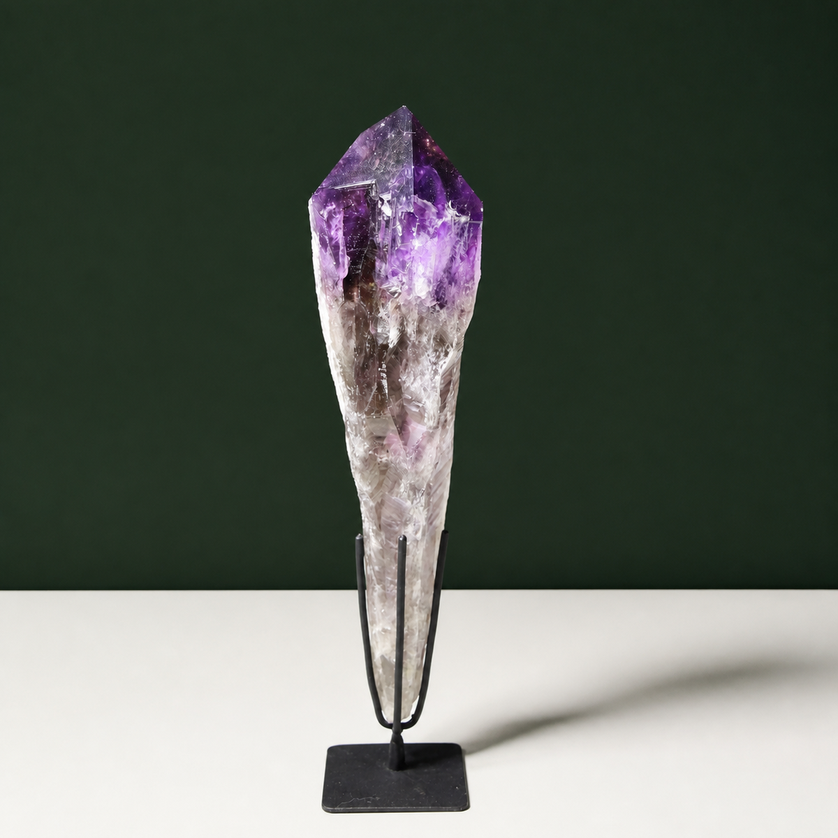 Sculptural naturally terminated amethyst wand on black metal stand