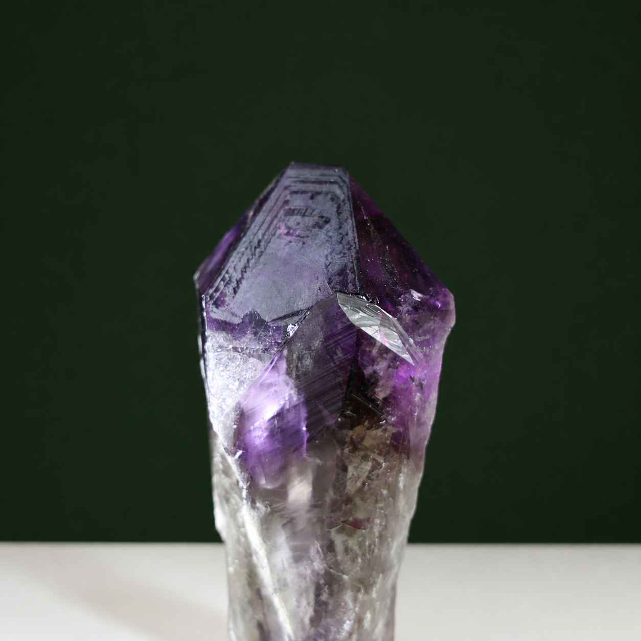 Natural termination detail on amethyst wand with growth markings