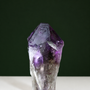 Natural termination detail on amethyst wand with growth markings