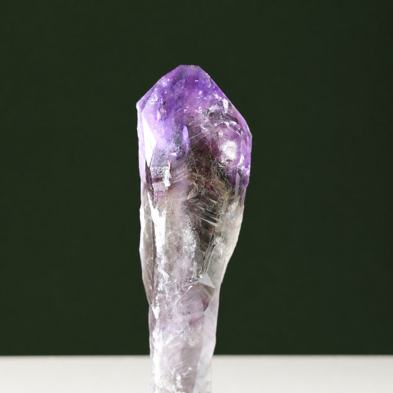 Slender natural amethyst point, front view
