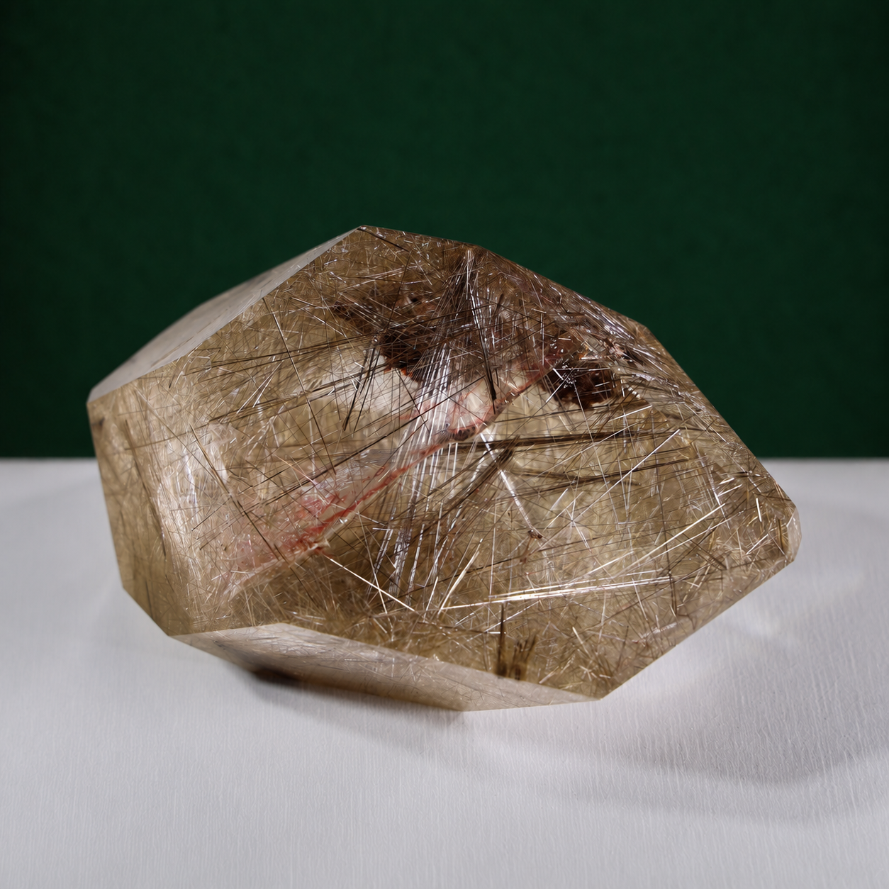 Polished rutilated quartz freeform, 417 g, angled view showing natural rutile inclusions.