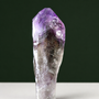 Slender natural amethyst point, side view