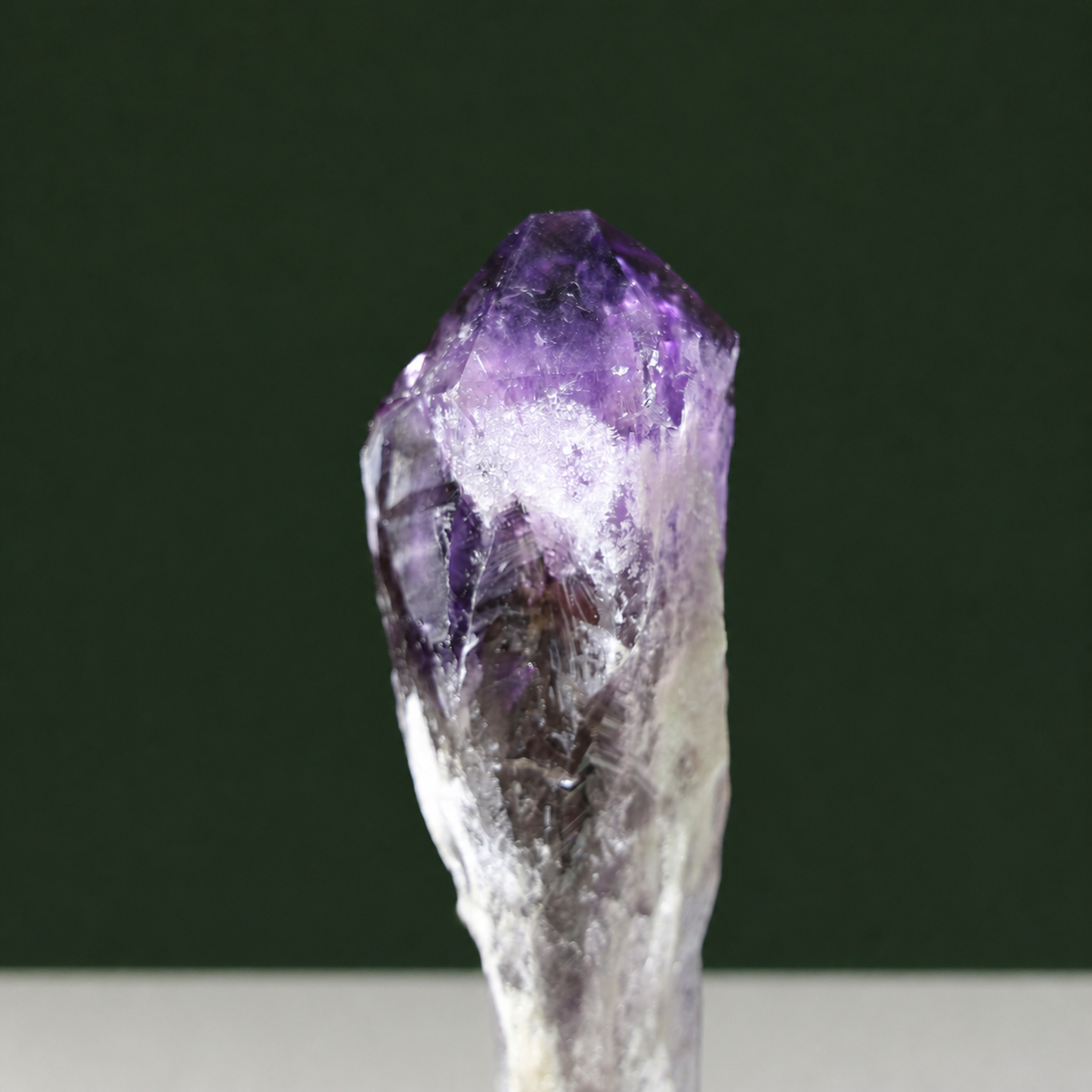 Growth markings detail on slender natural amethyst point