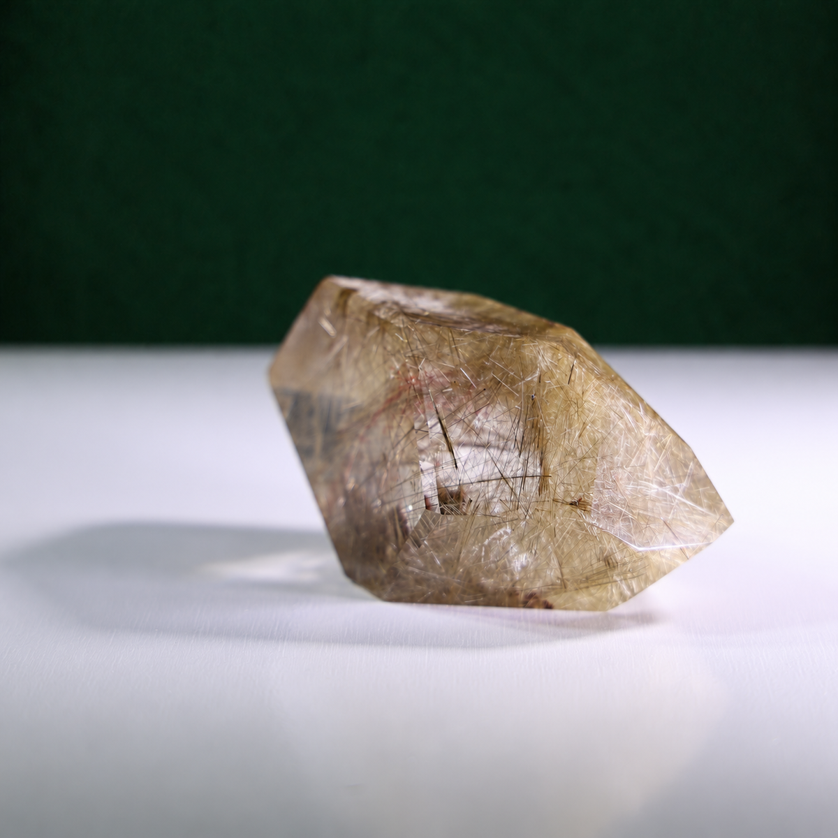 Polished rutilated quartz freeform, 417 g, detail angle showing natural rutile inclusions.
