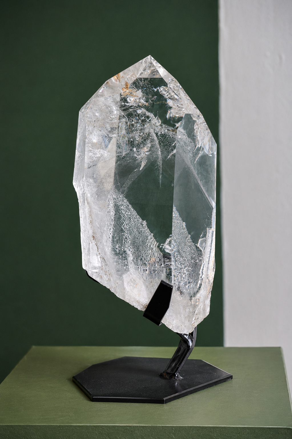 Front view of the collector-grade Lemurian phantom quartz on its display base