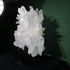 Full angled view of the quartz cluster on its black stand