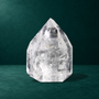 Polished quartz point showing broad facets and internal inclusions.
