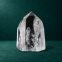 Polished quartz point with a visible rainbow, 0.575 kg, front view.