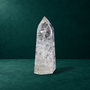 Polished quartz point, 1.049 kg, narrow side view