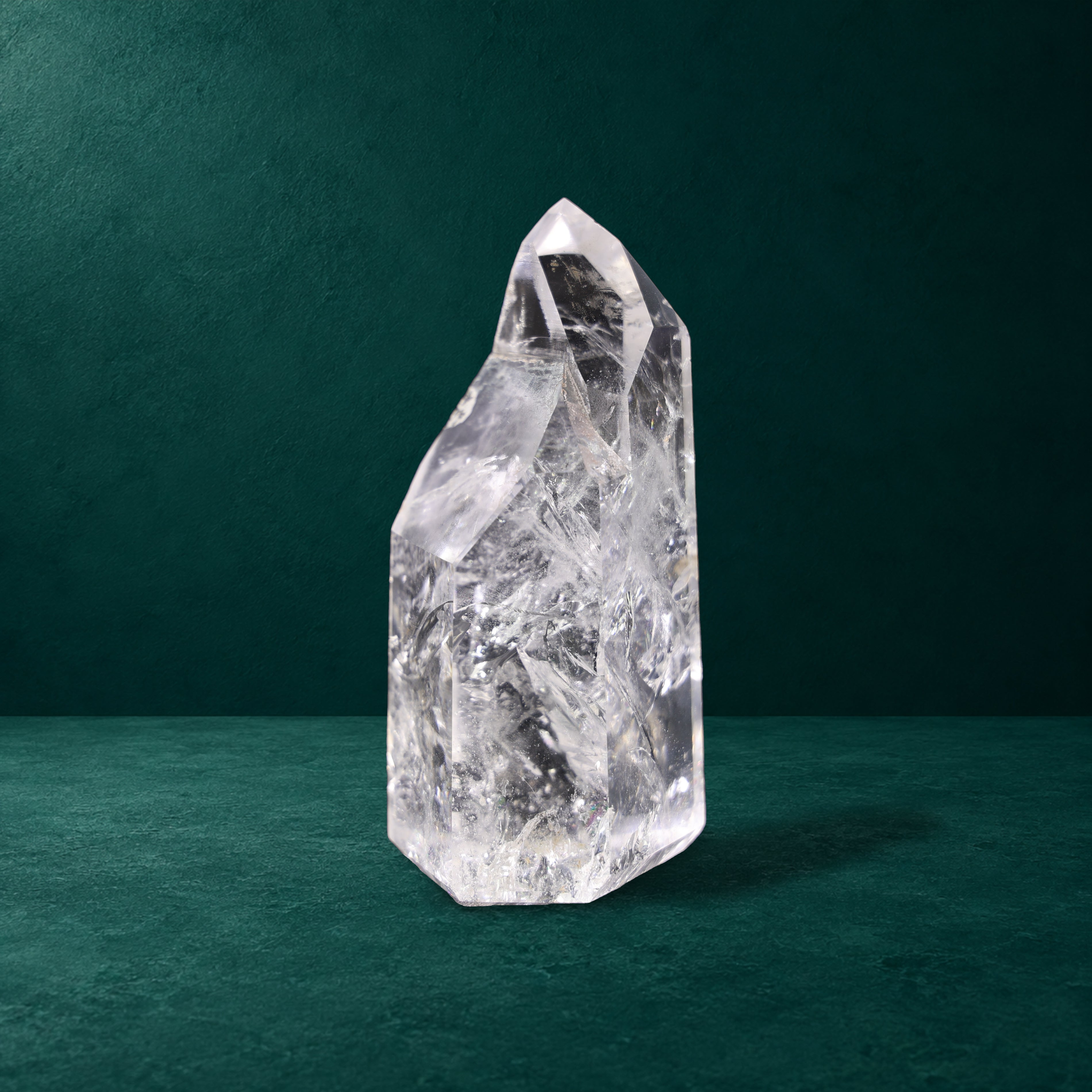 Polished quartz point, 0.718 kg, front view showing its natural shape.