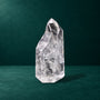 Polished quartz point, 0.718 kg, front view showing its natural shape.