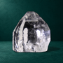 Polished quartz point, 0.760 kg, front view with natural regrowth