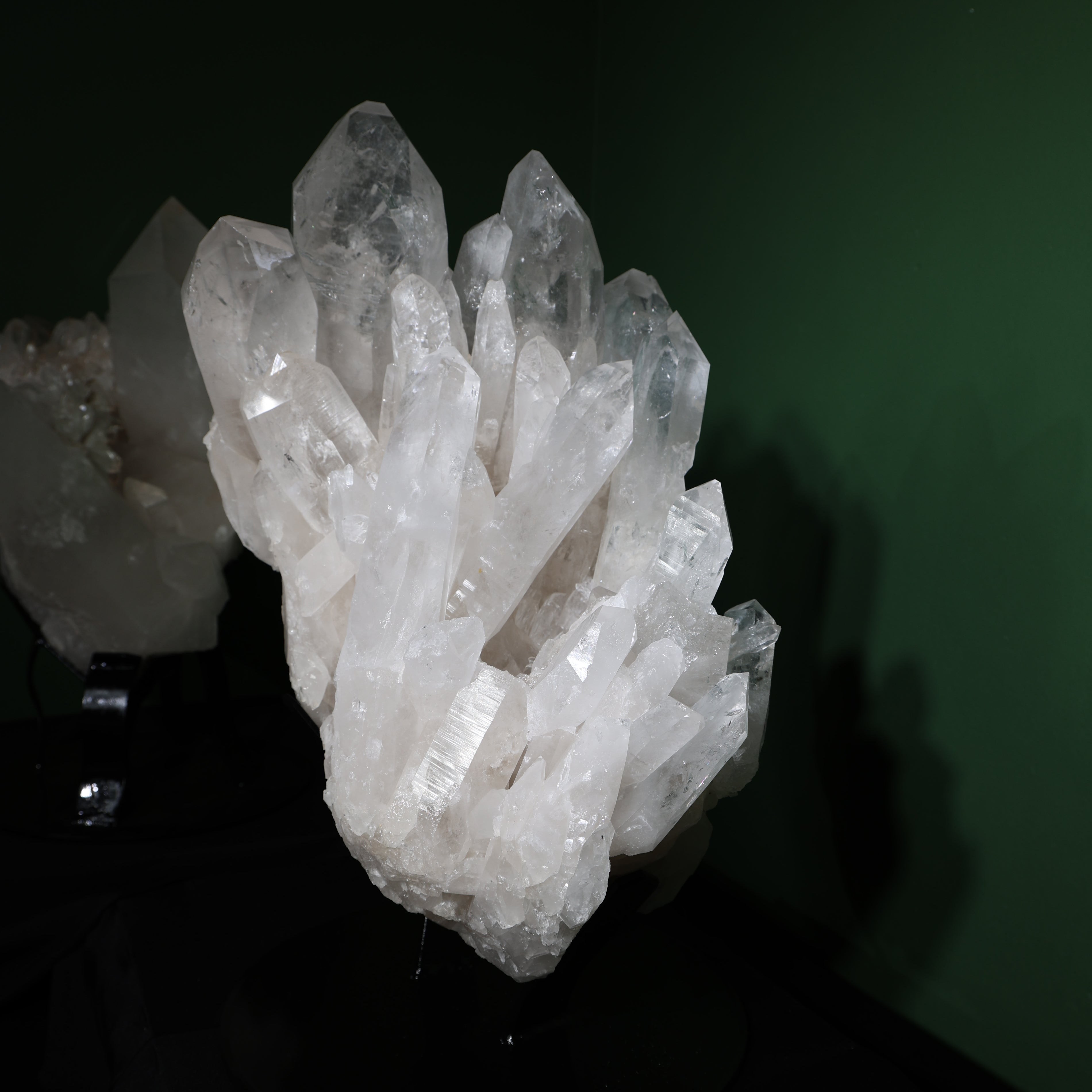 Front view of the upright Lemurian quartz cluster on its included display base