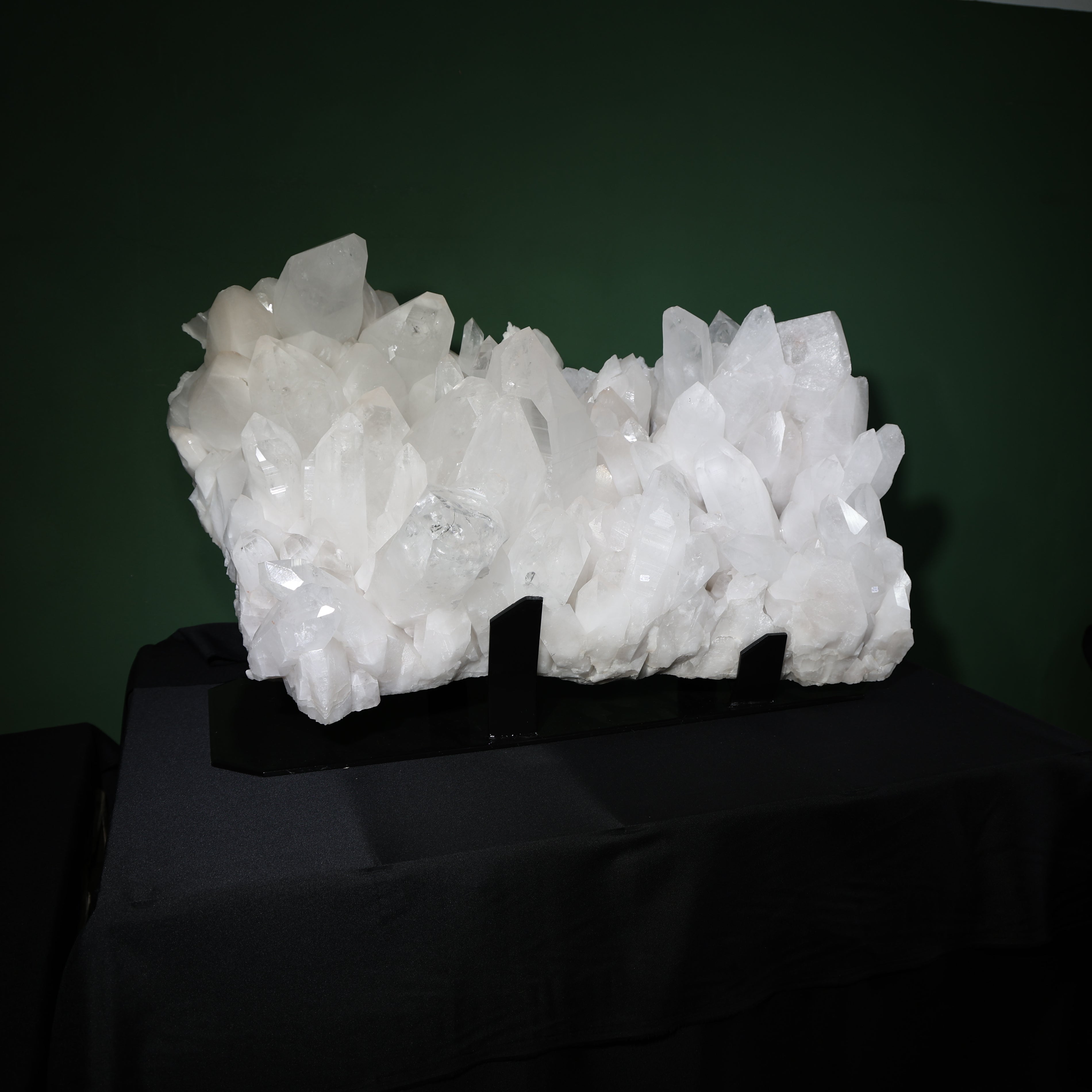 Front view of the wide self-healed Lemurian quartz cluster on its display base